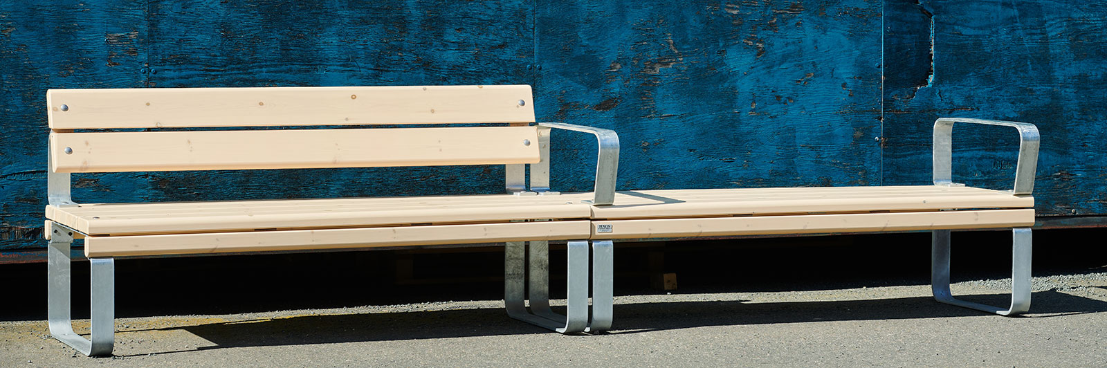 Modular park bench and bench on a sidewalk.